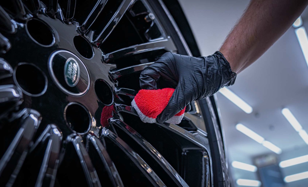 Ceramic coating being applied by hand to a Range Rover wheel