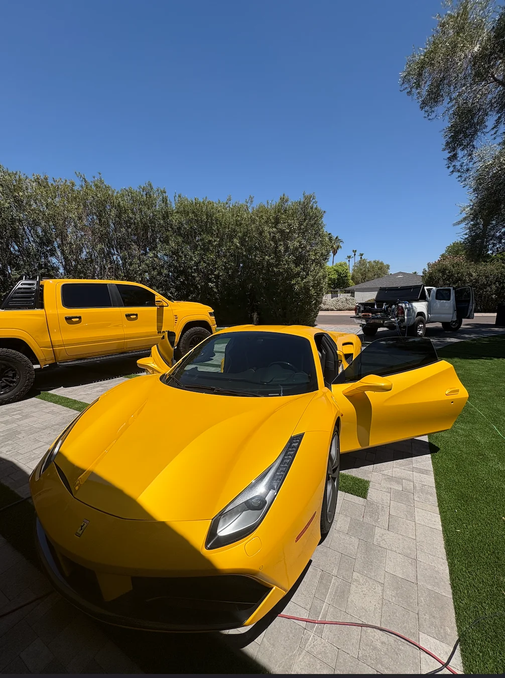 Freshly detailed yellow sports car in a driveway